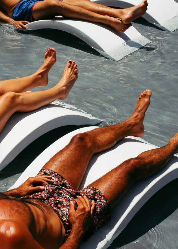 Man and woman getting sun at pool