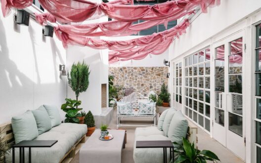 Picture of the decorative balcony with chairs and plant in the evening