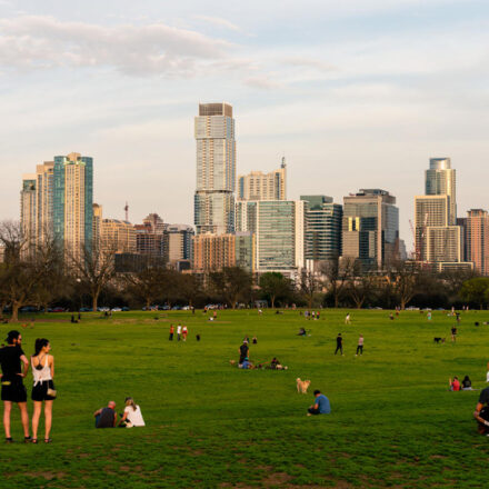 Picture of a public park with the city view and a lot of people
