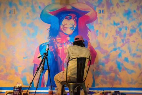 boy painting on a wall