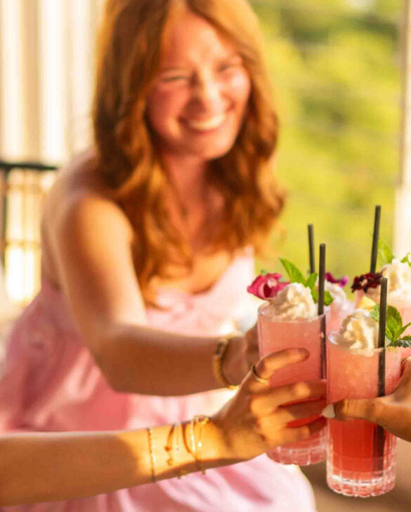 a group of people cheering with their drinks together