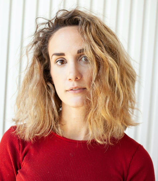 A woman with a medium-length hair and a red top