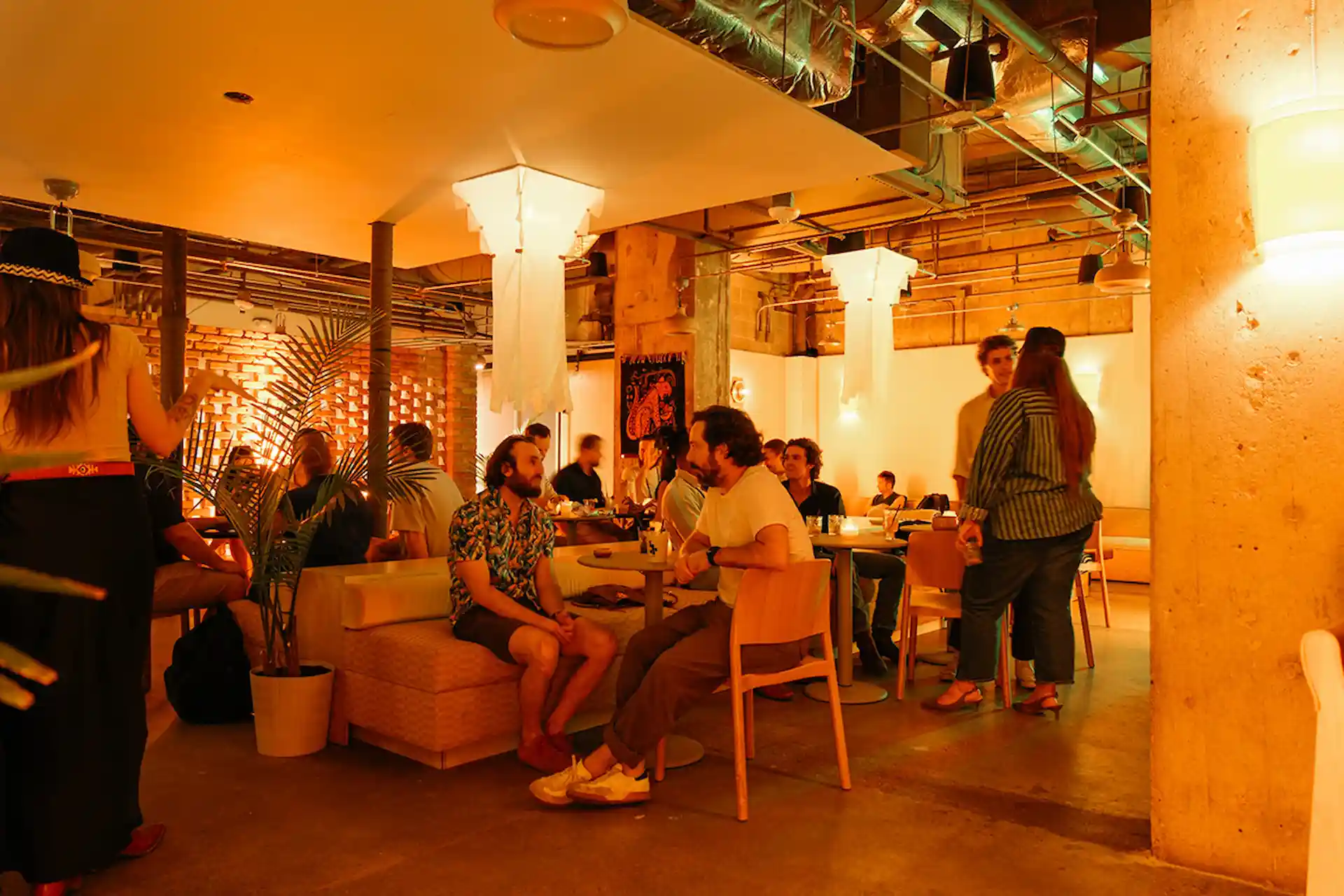 Guests socializing at Cantero inside The LINE Austin during Agave After Work, with ambient lighting and industrial design.