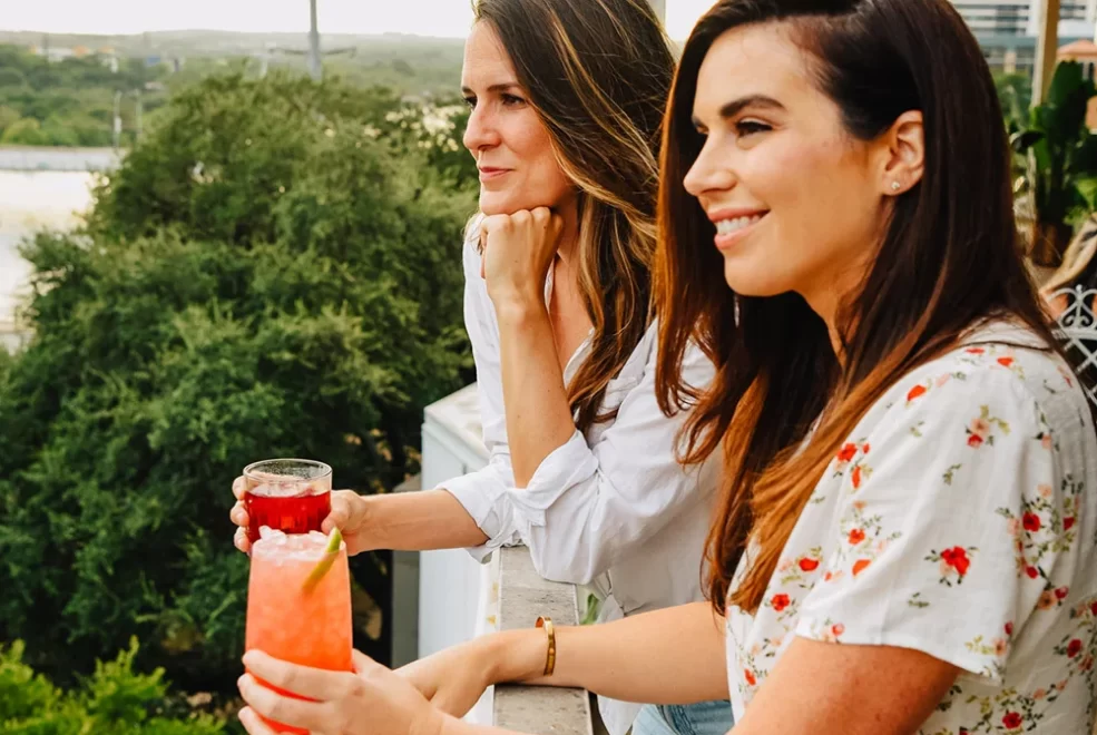 Two people enjoying cocktails on the rooftop overlooking the lakeview