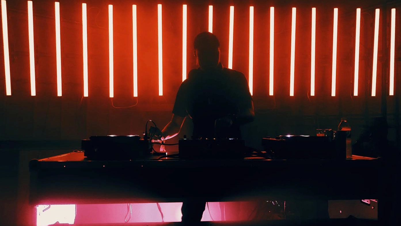 Charles Moon mixing song with the red light in the background